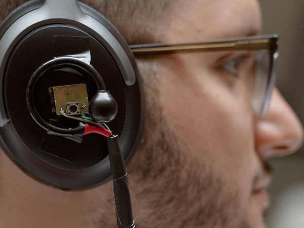 group-lab-mobile-intelligence-lab Closeup of AI-augmented headphone on person's ear